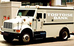 a tortoise bank armored car drives through the city